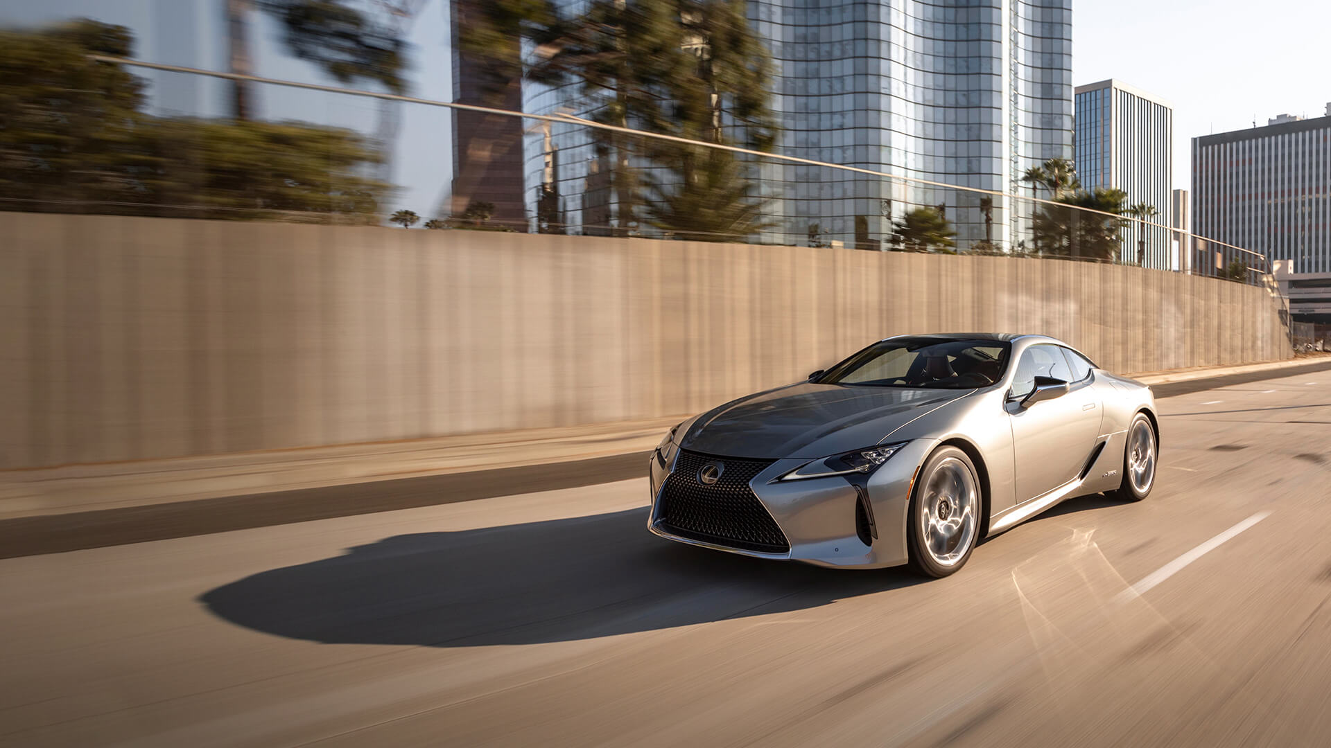 Silver Lexus LC being driven on the road.