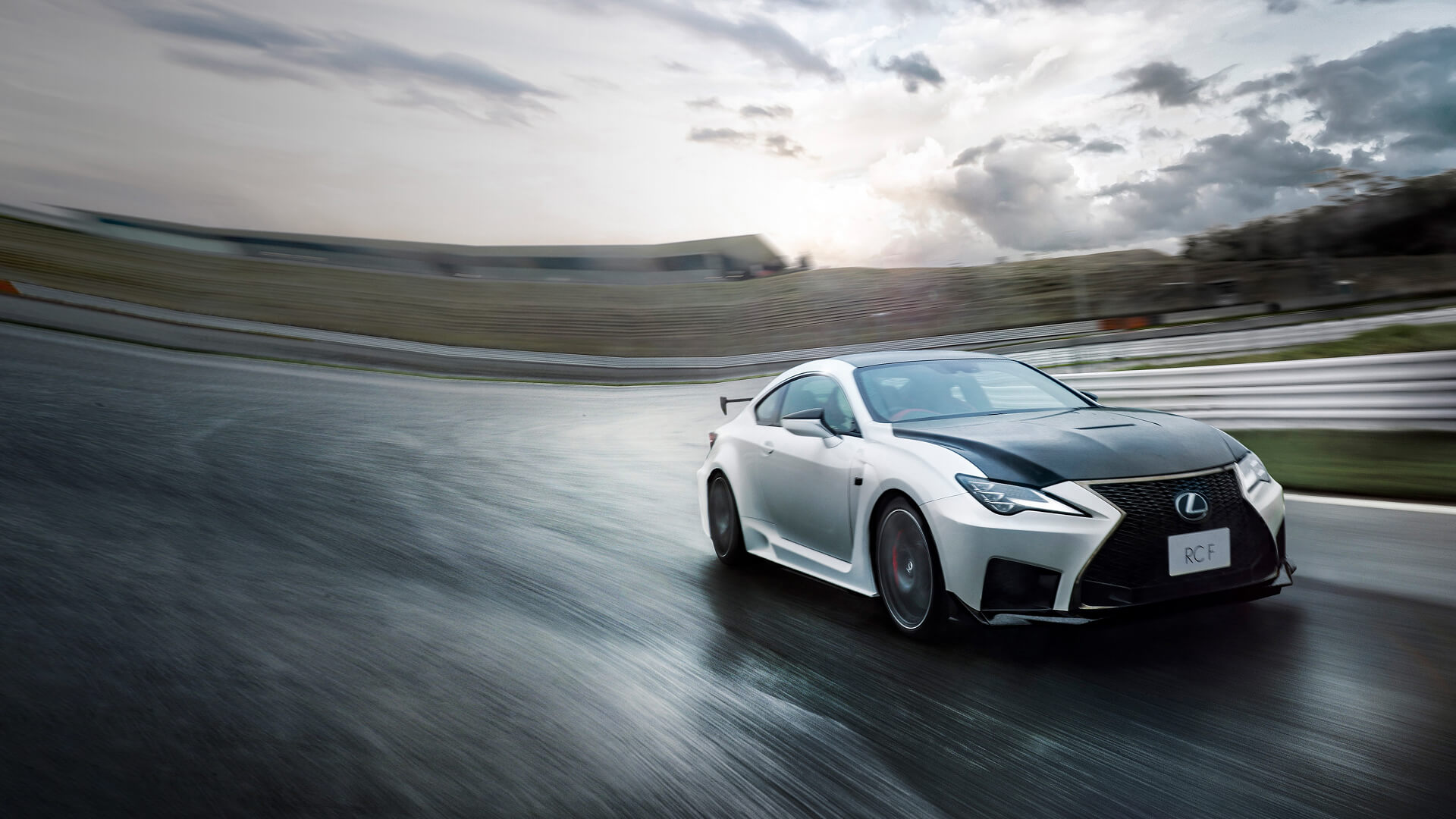 White Lexus RC F being driven on a race track.