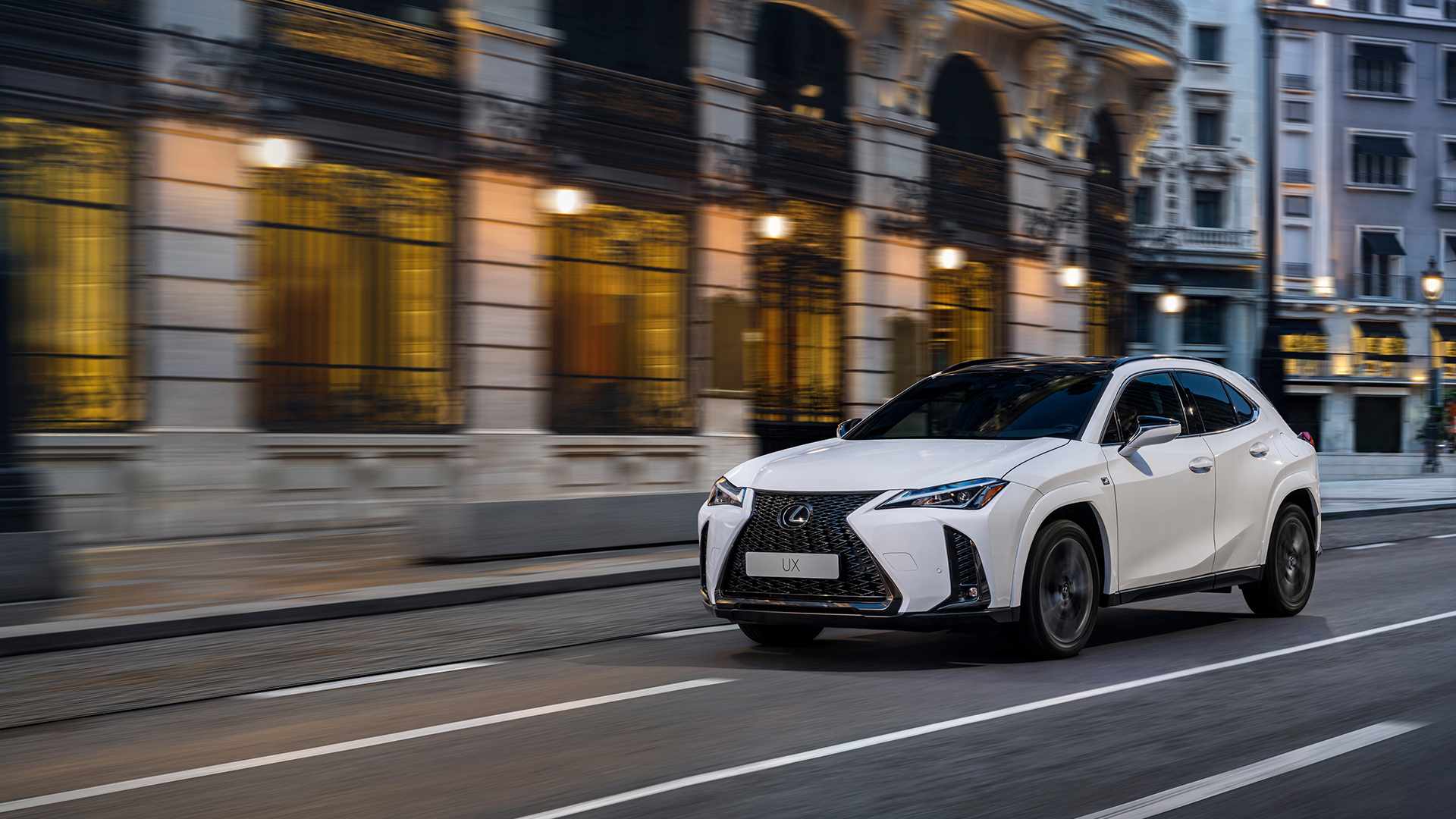 White Lexus UX driving through the city